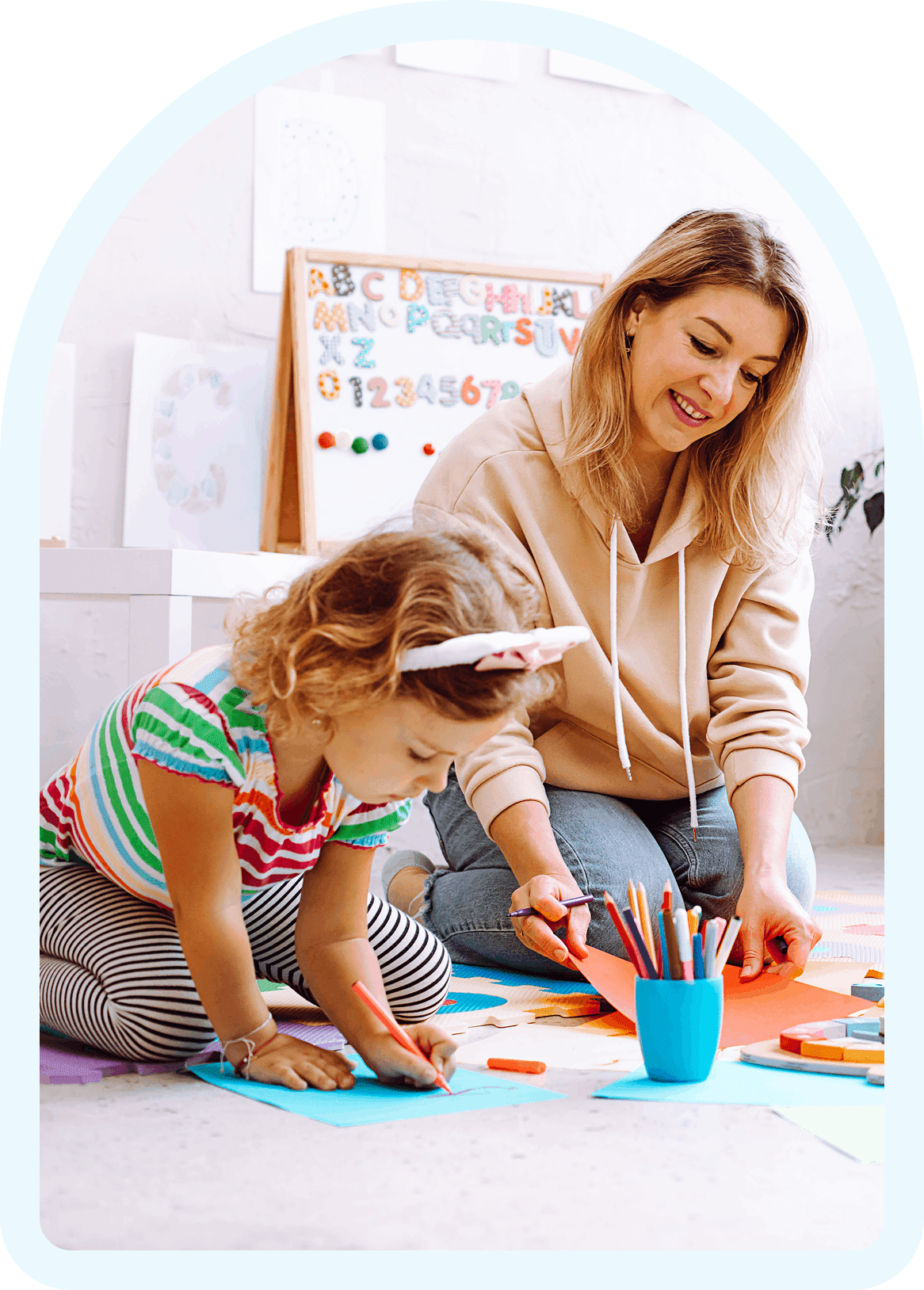 Child and adult drawing with colorful supplies.